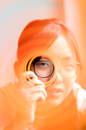 Girl looking through magnifier