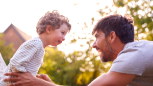 Loving Father With Son Having Fun In Garden At Home Together